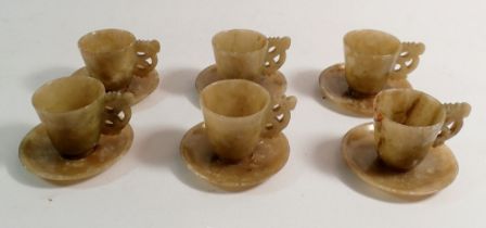 A set of six Qing Dynasty Chinese jade miniature cups, 4.5cm tall and saucers with carved handles