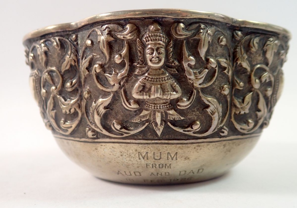 A Burmese white metal bowl with embossed foliage and deity, inscribed and dated 1926, maks to - Image 2 of 4