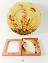 A Crown Ducal plate painted orange flowers and butterflies, 28cm diameter and a Crown Devon preserve