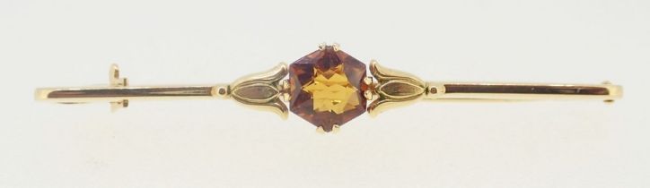 An 18 carat gold bar brooch set orange topaz, 1.6g, boxed