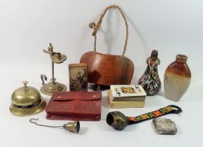 A box of collectables including rush nip holder, stoneware flask, brass table bell etc.