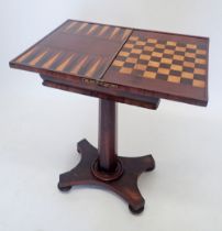 A Regency rosewood fold top games table with inlaid chess and backgammon boards al raised on