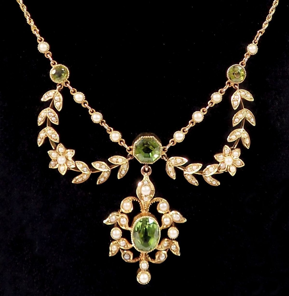 An Edwardian 15ct gold necklace set peridots with seed pearl set flower and leaf surrounds, 11. - Image 2 of 3