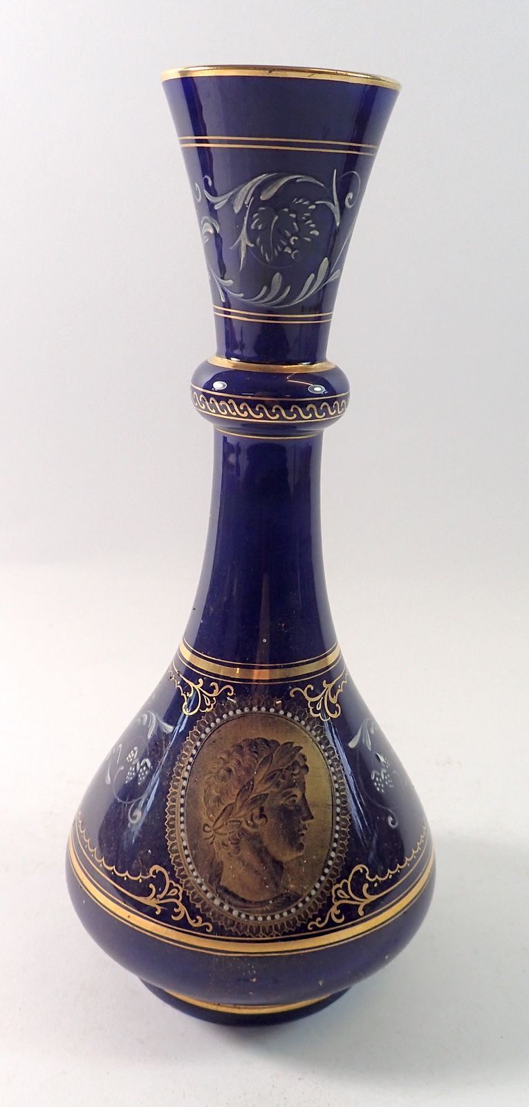 A blue porcelain vase with pate sur pate classical decoration and classical gilt bust, 26cm tall