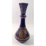 A blue porcelain vase with pate sur pate classical decoration and classical gilt bust, 26cm tall