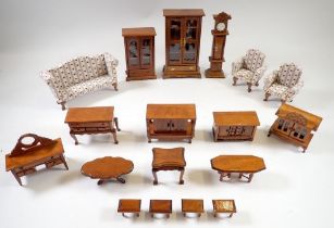 A collection of dolls house furniture including three piece suite, cabinets etc.