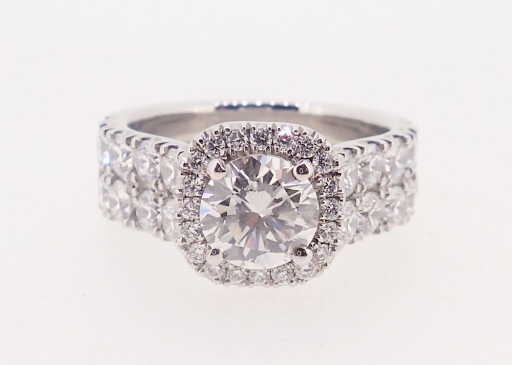 A fine modern platinum ring set brilliant cut diamond within diamond surround, the band half set - Image 2 of 6