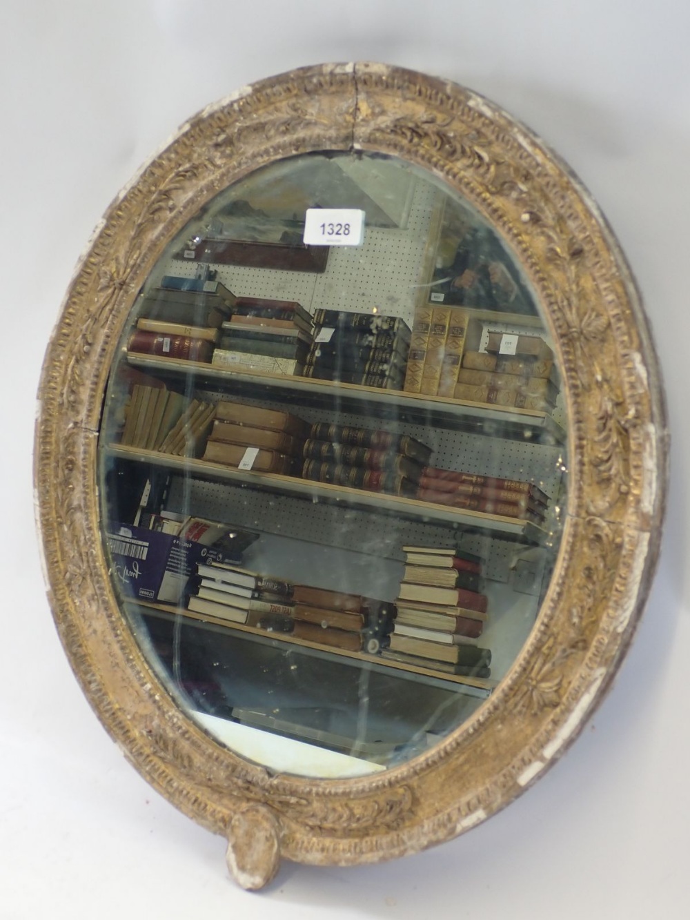 A Georgian gilt framed oval mirror moulded foliate sprays, 50 x 43cm