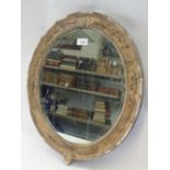 A Georgian gilt framed oval mirror moulded foliate sprays, 50 x 43cm