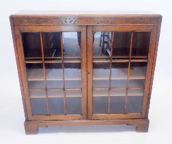 An early 20th century oak glazed two door bookcase, 105cm wide