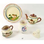 A Doulton Buzfuz bust, a Poole vase and a Torquay Ware teapot, jug and plate