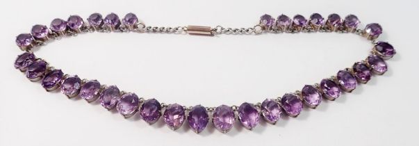 A white metal and amethyst paste graduated necklace