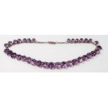 A white metal and amethyst paste graduated necklace