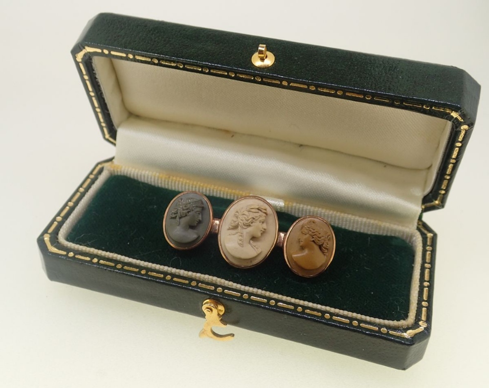 A 19th century gold brooch set three lava carved cameos in three colours, boxed, 3.3cm wide - Image 3 of 3