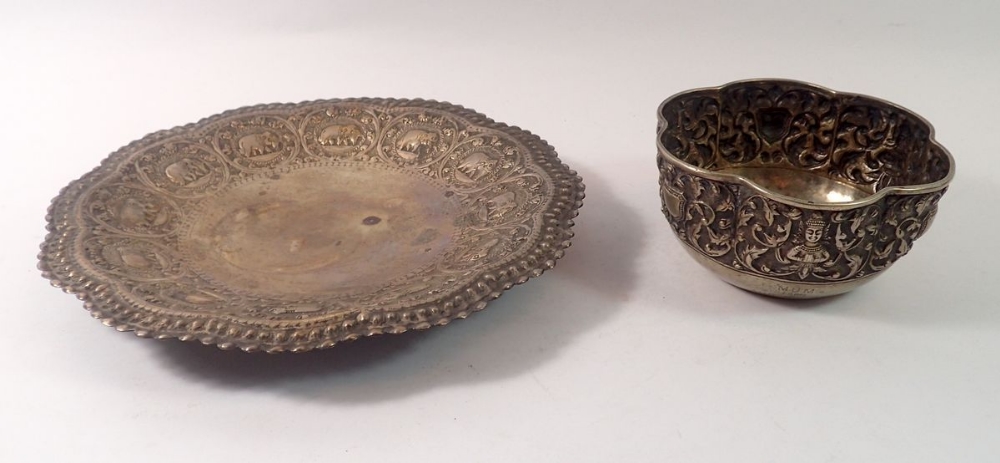 A Burmese white metal bowl with embossed foliage and deity, inscribed and dated 1926, maks to