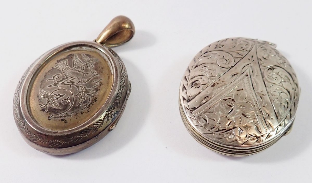 A silver oval engraved locket 4 x 3.2cm and a white metal locket engraved bird a/f