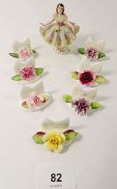 A set of seven Coalport floral table place name settings together with a small Dresden figure of a