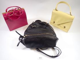 A vintage yellow patent handbag, a pink one and a Radley small leather rucksack handbag