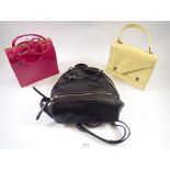 A vintage yellow patent handbag, a pink one and a Radley small leather rucksack handbag