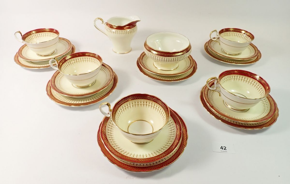 An Aynsley tea service with red and gilt borders, No. 7799 comprising five cups and six saucers, six