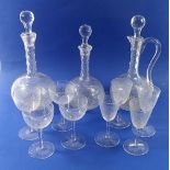Three Victorian facet cut glass decanters, four cocktail glasses and four sherry glasses, all etched