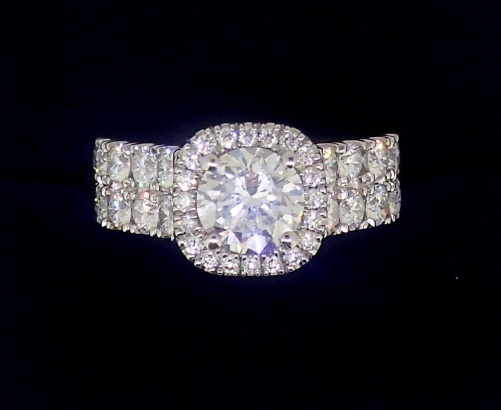 A fine modern platinum ring set brilliant cut diamond within diamond surround, the band half set