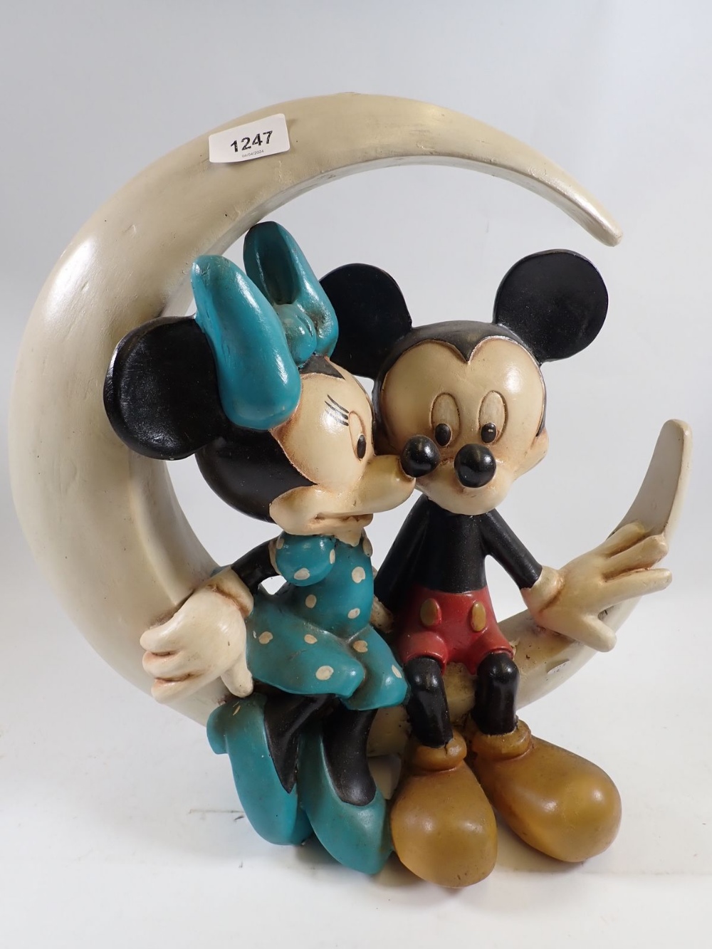 A vintage composition large Mickey & Minnie Mouse figure group seated on a crescent moon, marked