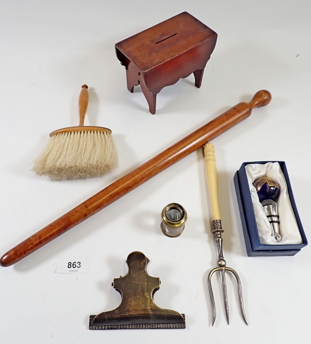 A treen table form money box, a magnifier and brass paperclip and a Scottish spurt (porridge