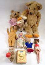 An antique gold plush teddy and various small vintage teddies and dolls etc.