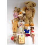 An antique gold plush teddy and various small vintage teddies and dolls etc.