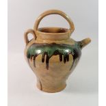 A stoneware jug with green dribbled glaze, 24cm