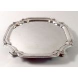 A silver card tray on four feet, London 1973, 324g, 19cm x 19cm by Wakely and Wheeler