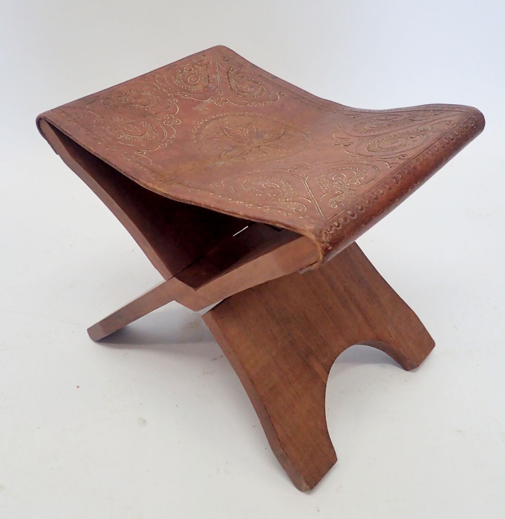 A camel saddle stool, 39cm wide