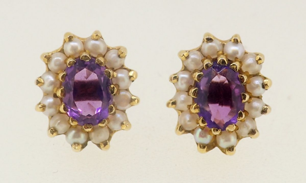 A pair of 9 carat gold earrings set amethysts and seed pearls