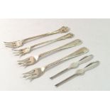 Four various silver seafood forks and two silver small seafood picks, 110g