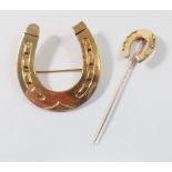 An Edwardian 15 carat gold horseshoe stick pin and a gold plated large horseshoe brooch, 4.5 x 4cm