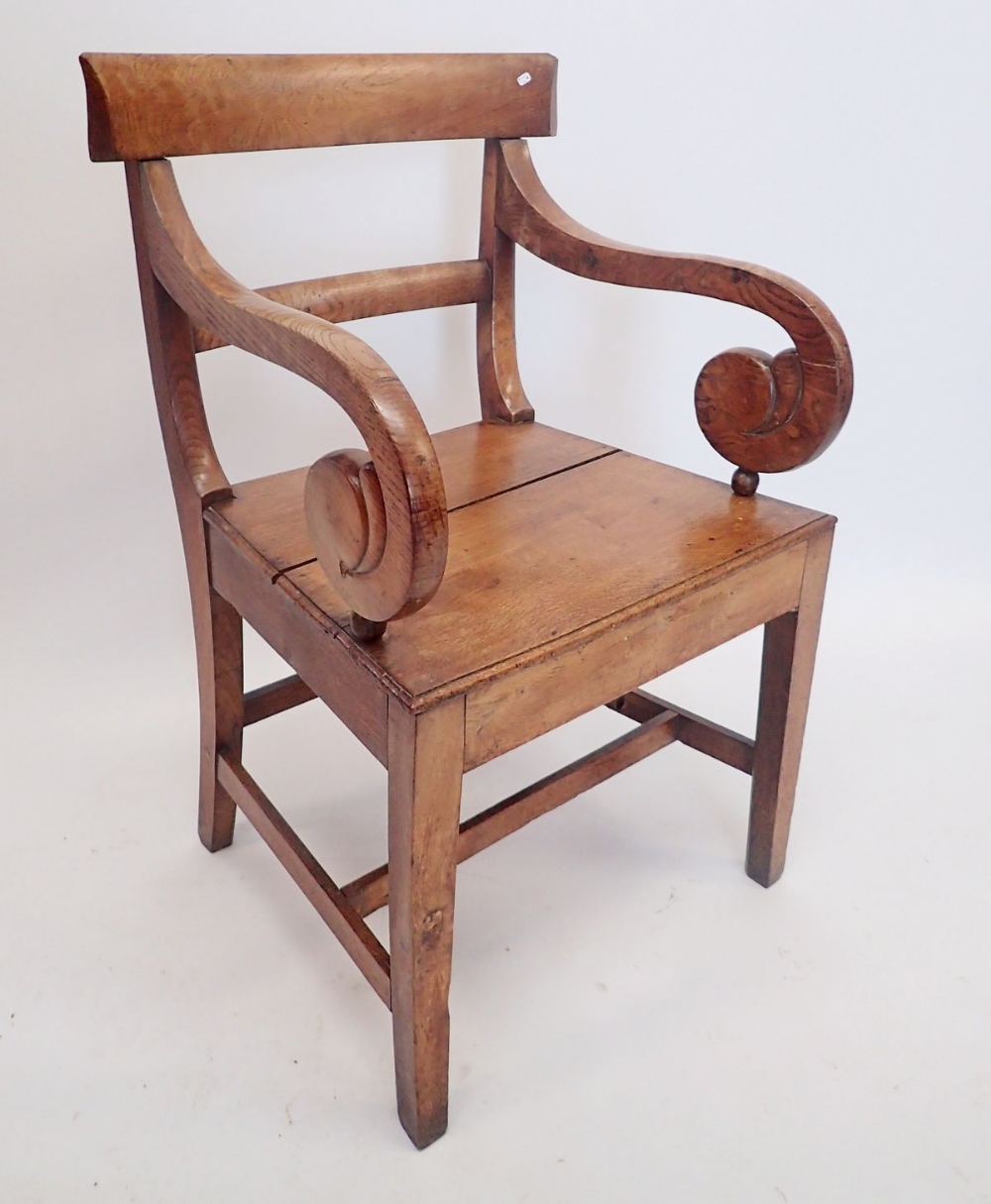 A Regency oak carver chair with scroll over arms