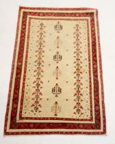 A Persian rug with garden motifs on a cream ground, 156 x 106cm