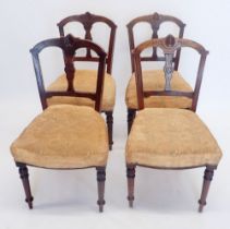 A set of four Victorian Aesthetic style dining chairs with incised decoration