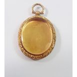 A Victorian 9 carat gold oval locket with engraved decoration and glazed to verso, 9g, 4 x 3.3cm