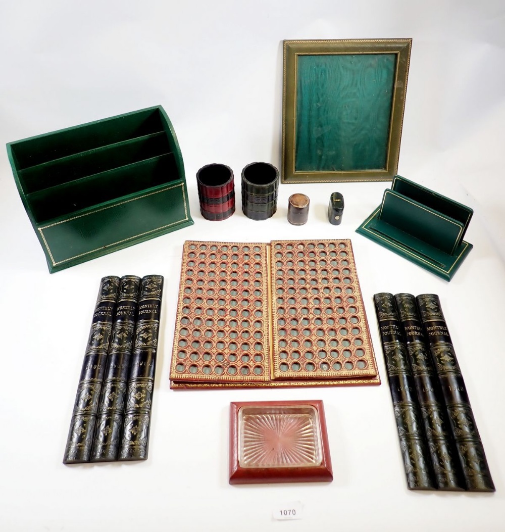 A box containing various leather desk items including a Smythson letter rack, blotter, picture