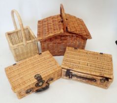 Three wicker picnic baskets and a wicker basket with handle