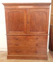 A 19th century mahogany small linen press with two arch panelled doors enclosing trays all over