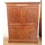 A 19th century mahogany small linen press with two arch panelled doors enclosing trays all over