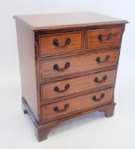 A reproduction small chest of two short and three long drawers, 63 x 40.5 x 73cm