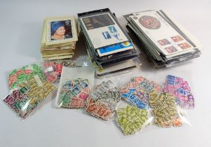 A box of stamps, mainly GB packs, First Day Covers and postcards