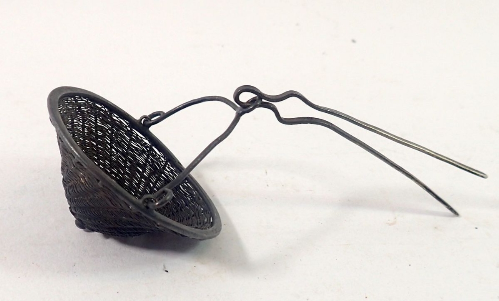 A Chinese white metal filigree coolie hat form tea strainer