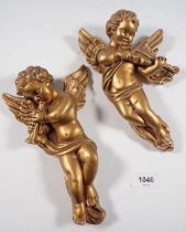Two gilt cherub moulded ornaments, 22cm tall