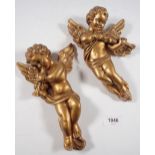 Two gilt cherub moulded ornaments, 22cm tall