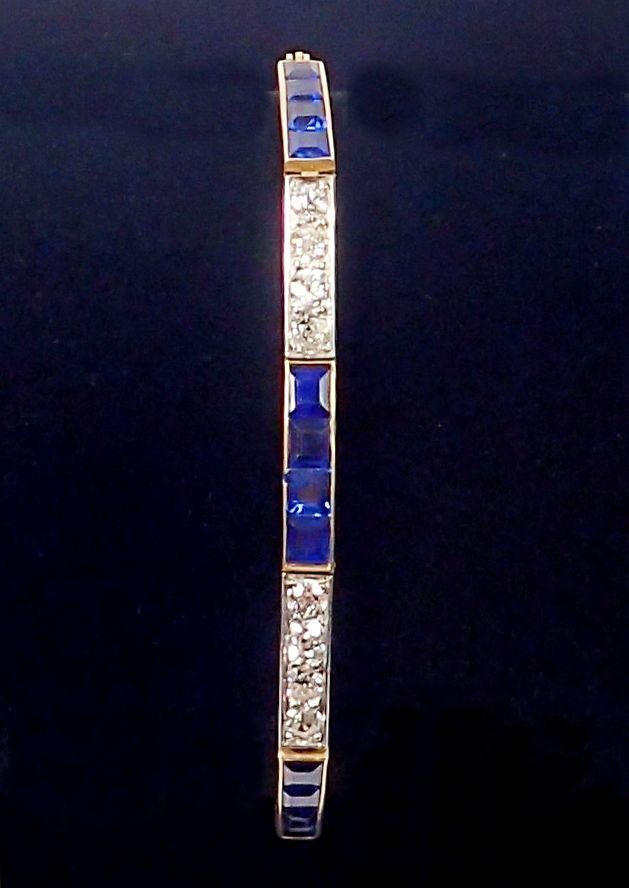 An 18 ct gold bracelet line set alternate links of brilliant cut diamonds and square cut